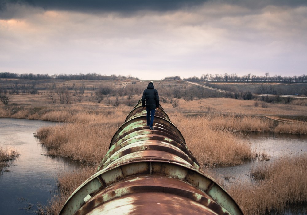 Man walking on a pipeline